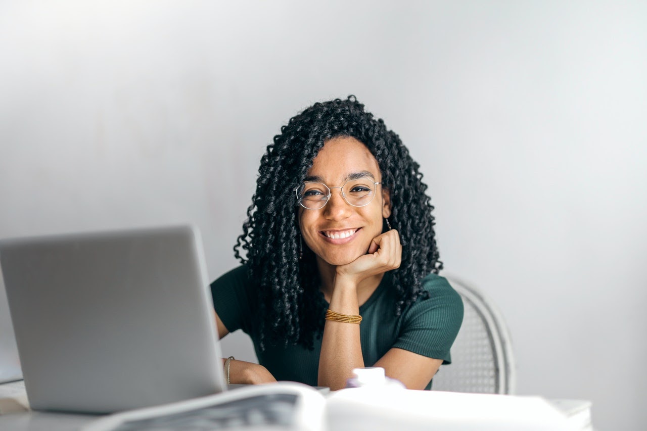 girl sitting at laptop smiling