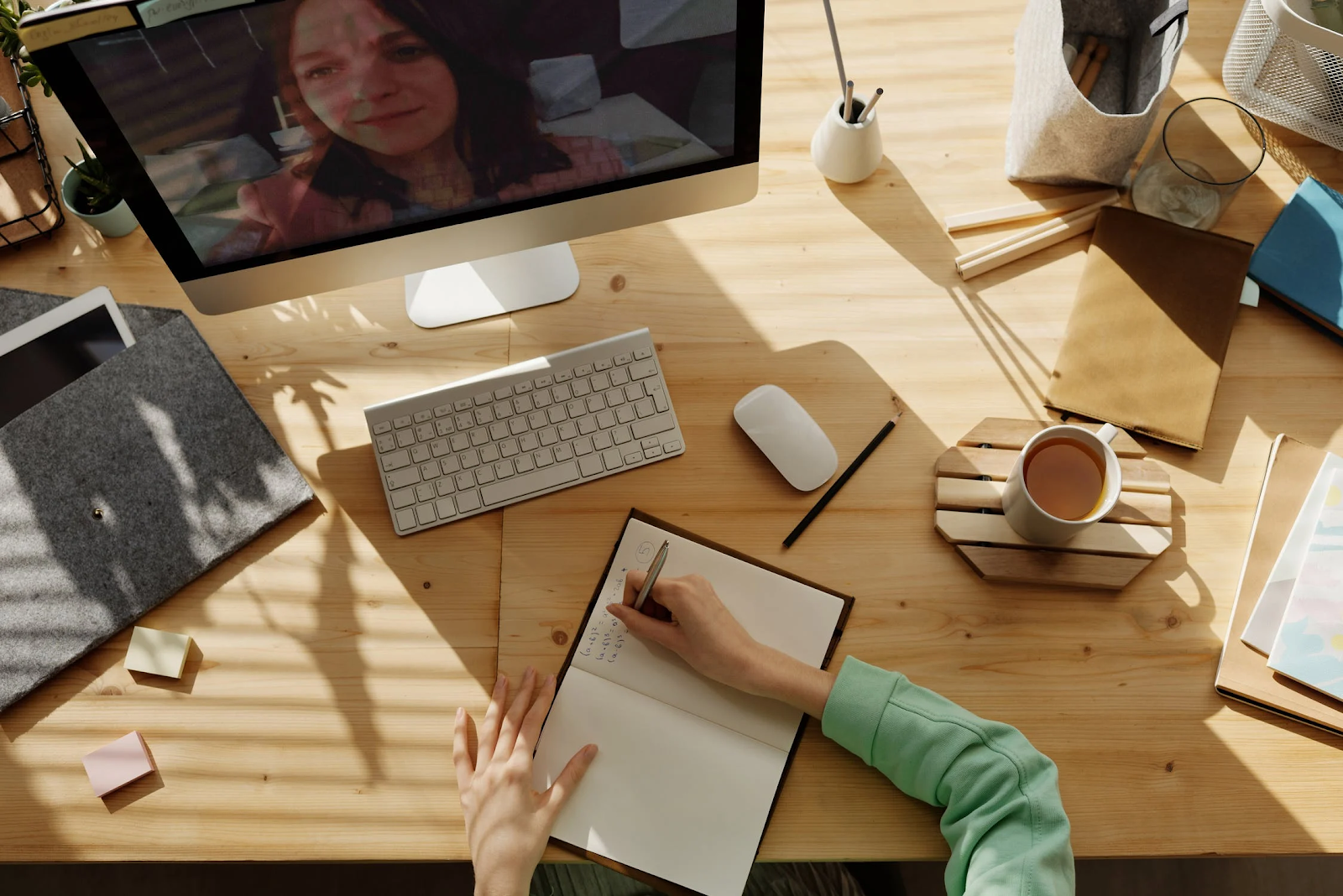 student taking notes in an online tutoring session