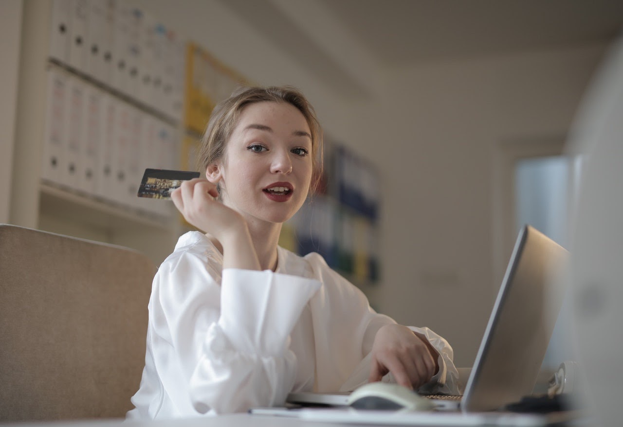 Student with debit card paying for online tutor