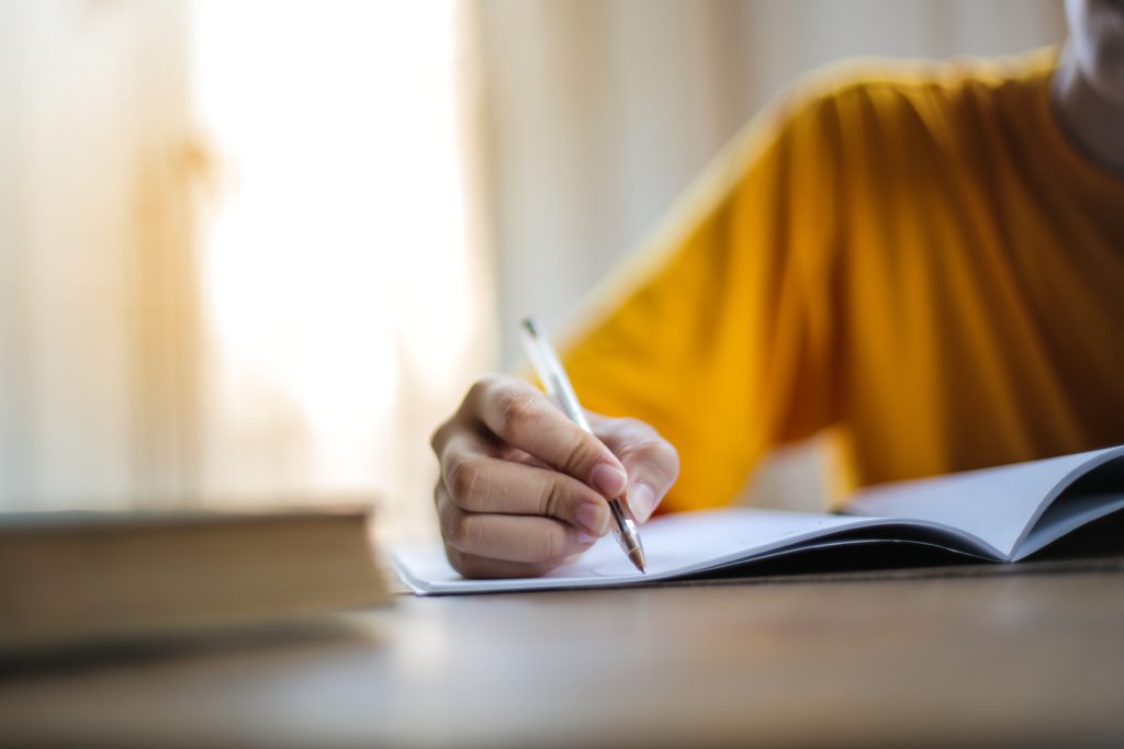 student taking notes in book