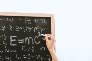 writing formulae on chalkboard