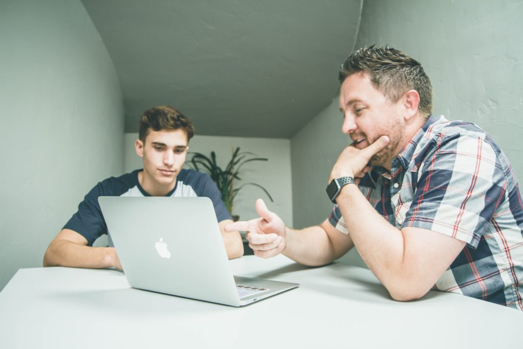 Tutor and student looking at the computer