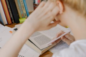 Student reading from book