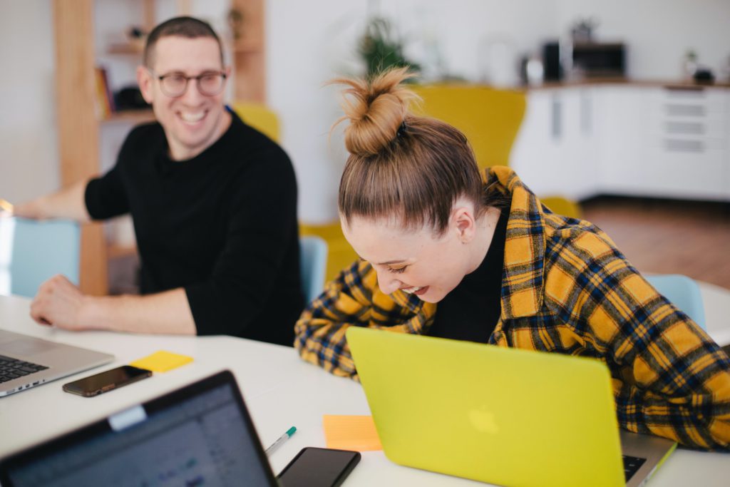 students smiling over computers