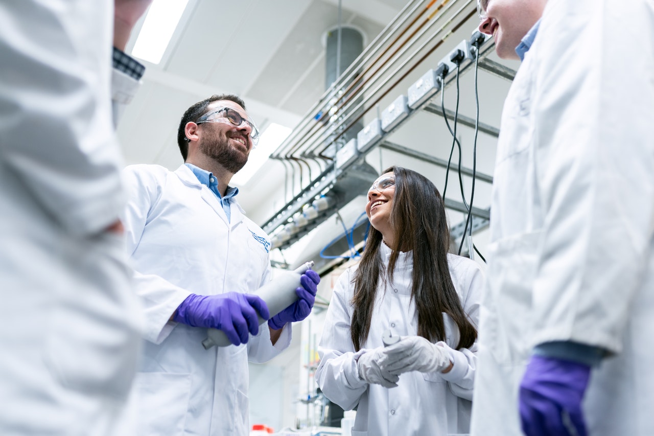 group of scientists talking in lab