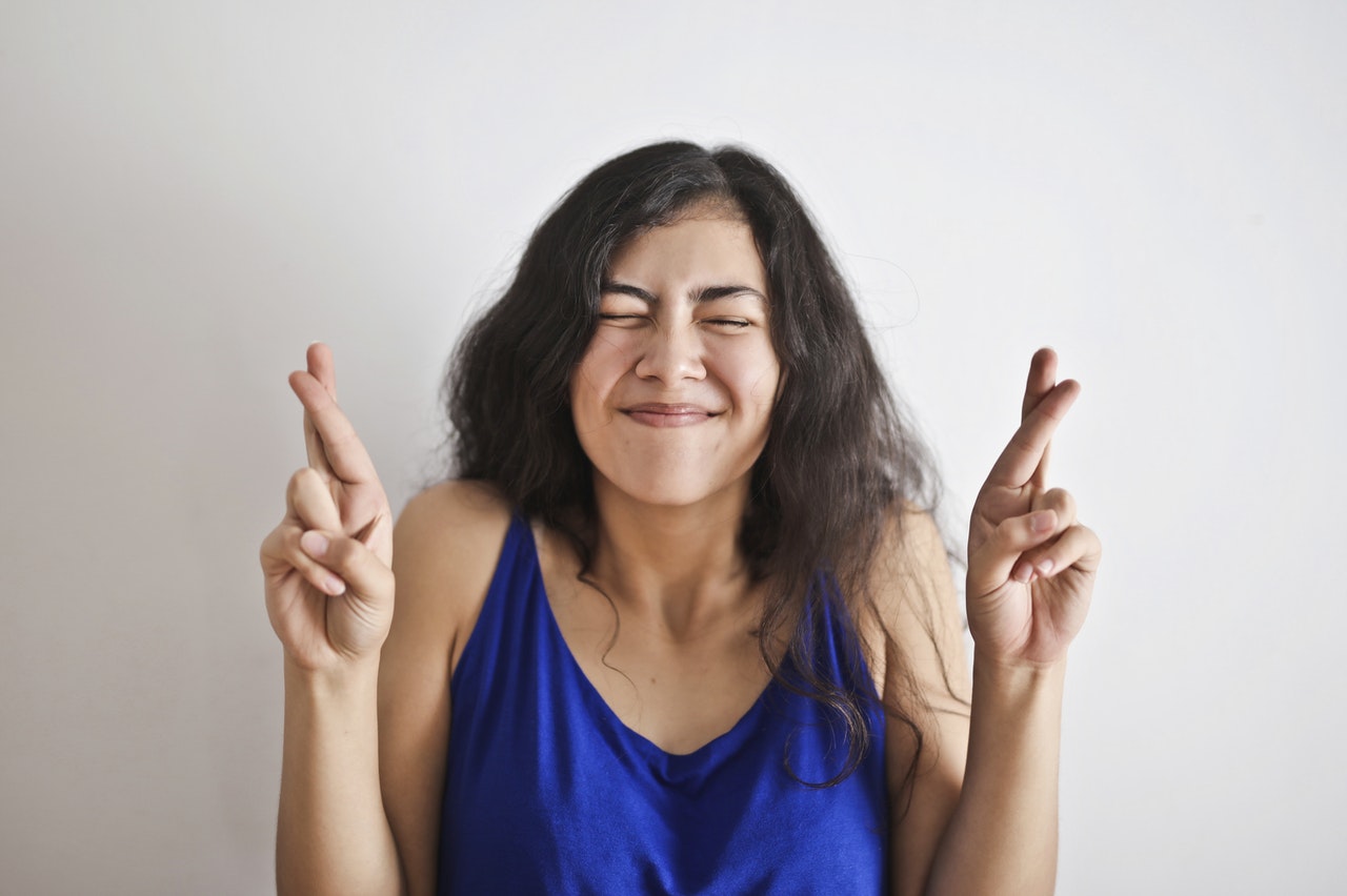 girl with both fingers crossed