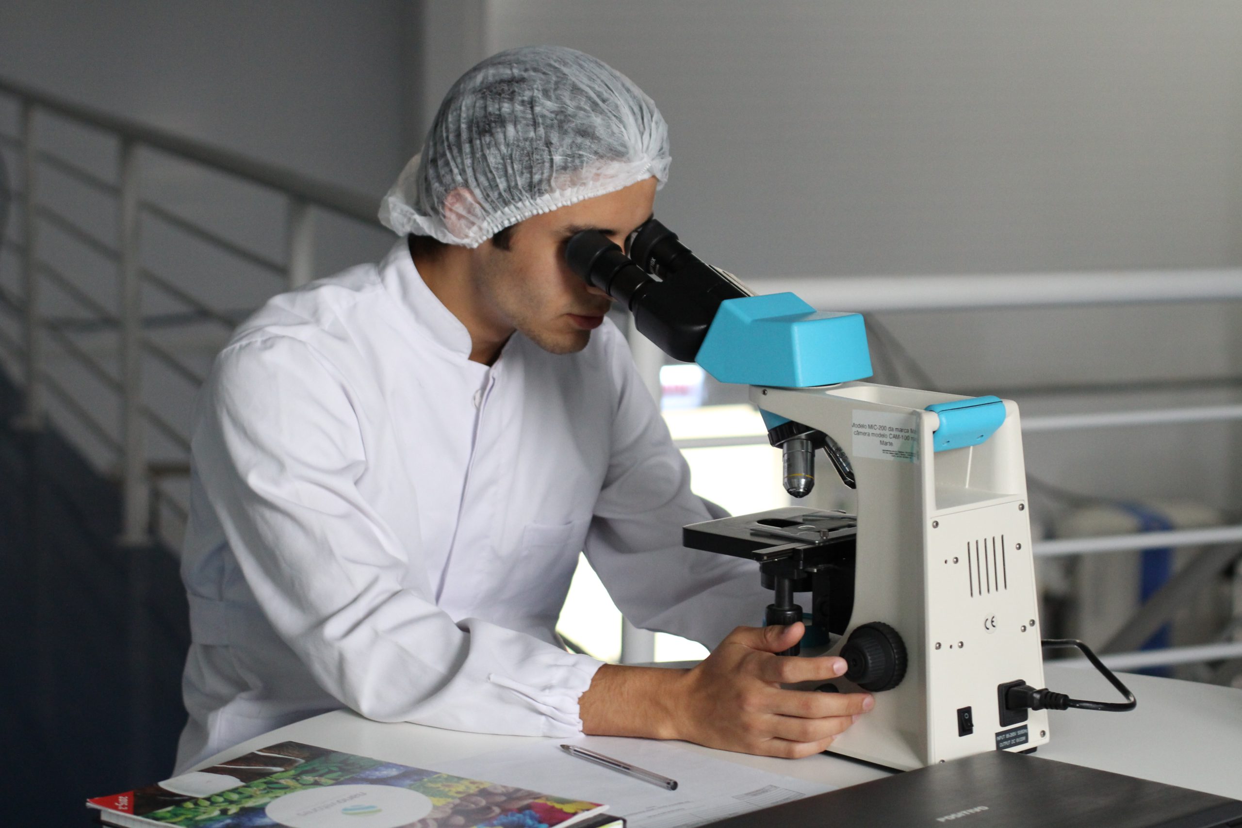 scientist using microscrope