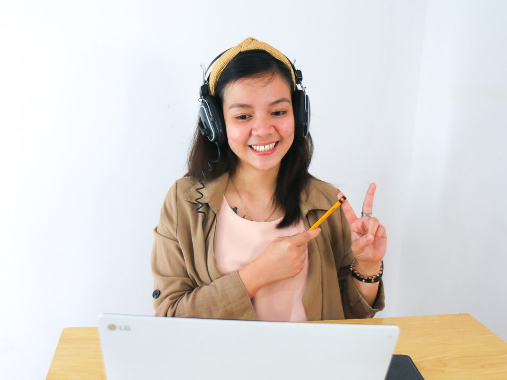 girl counting on fingers looking at laptop