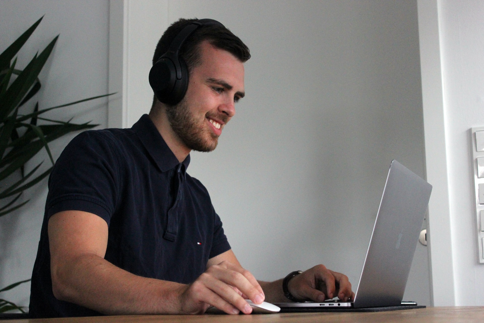 man smiling using mac book