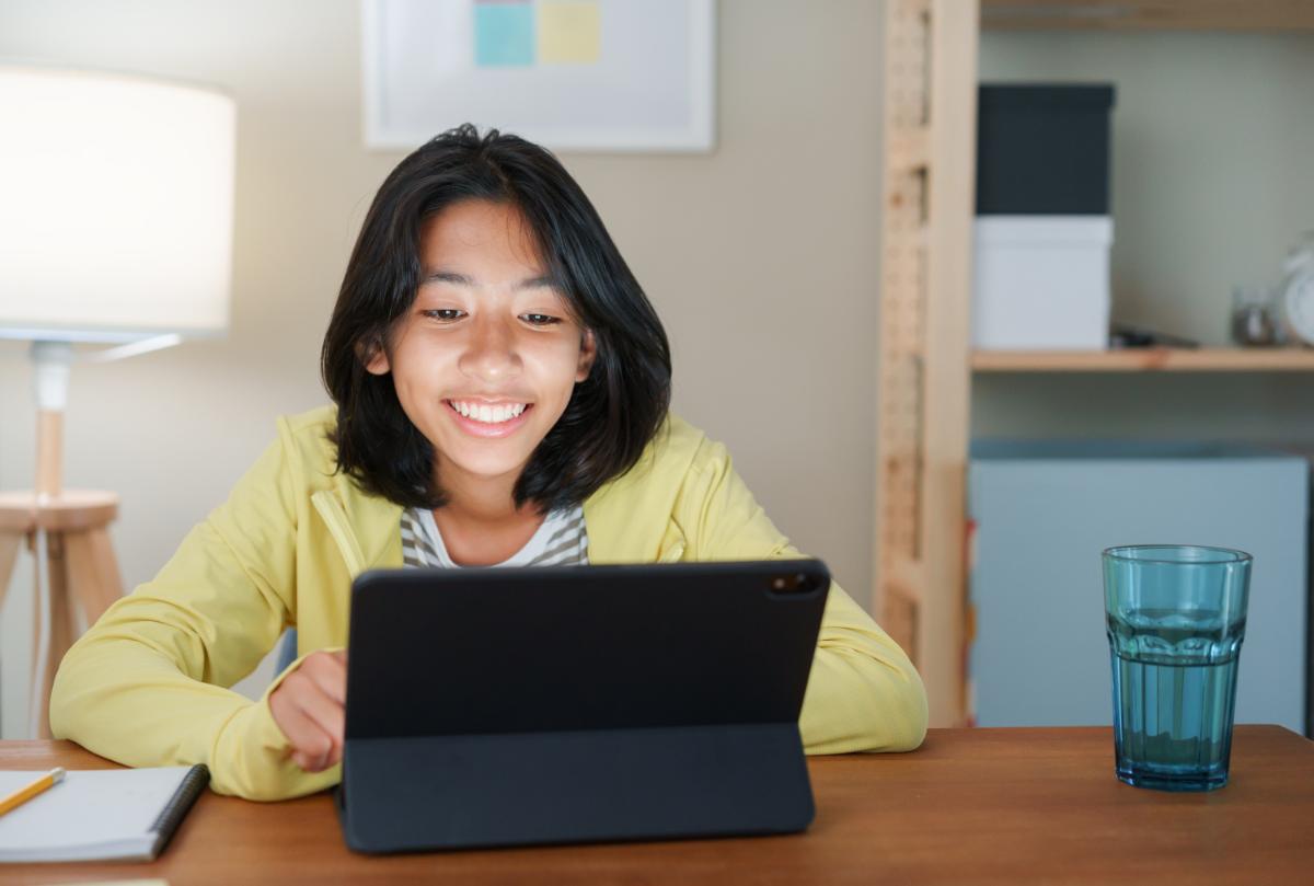 Student using laptop to study with online tutor