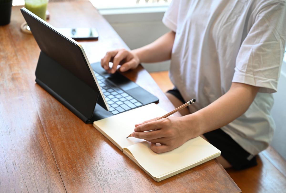 Young GCSE student using laptop to study online