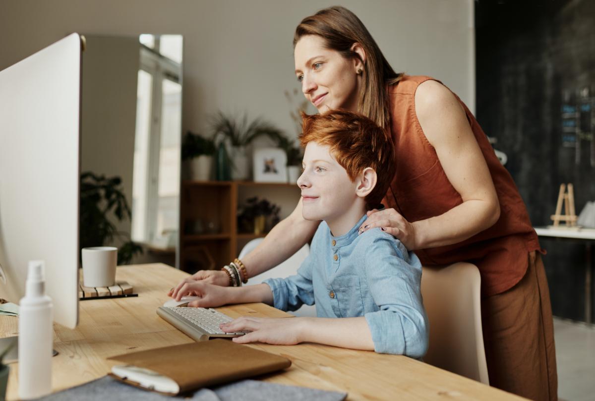 Parent helping GCSE student in online tuition class