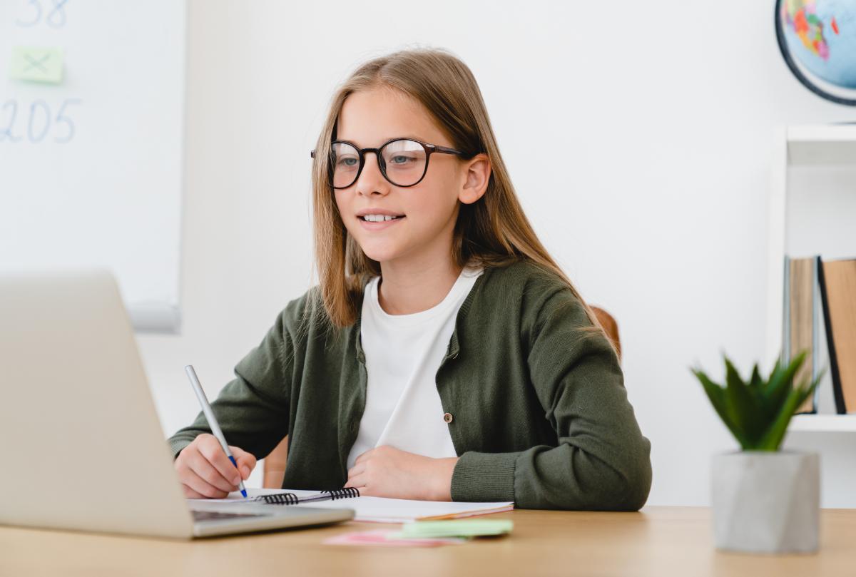 Young female student working with tutor online