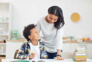 Parent helping GCSE student study at home