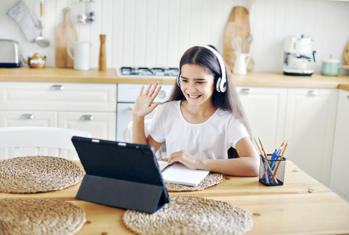 Student waving at her online tutor