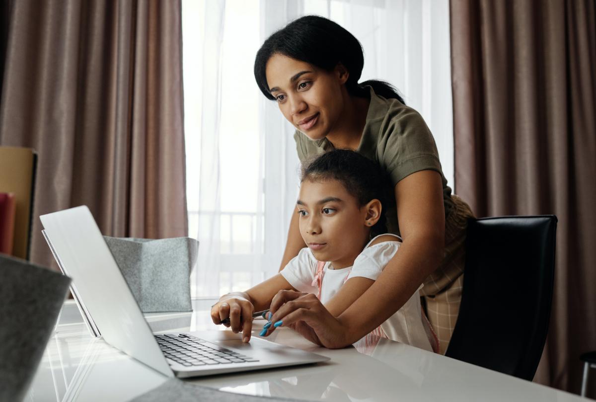 Parent helping child study at home